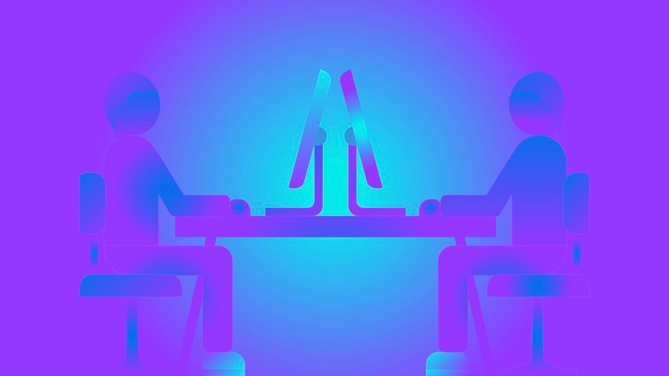 Transpersonal Image 27: Two seated human figures face each other across a desk with upright computer screens.